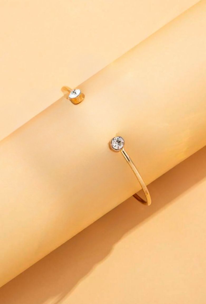 Brățară rafinată aurie cu forme organice și pietre discrete